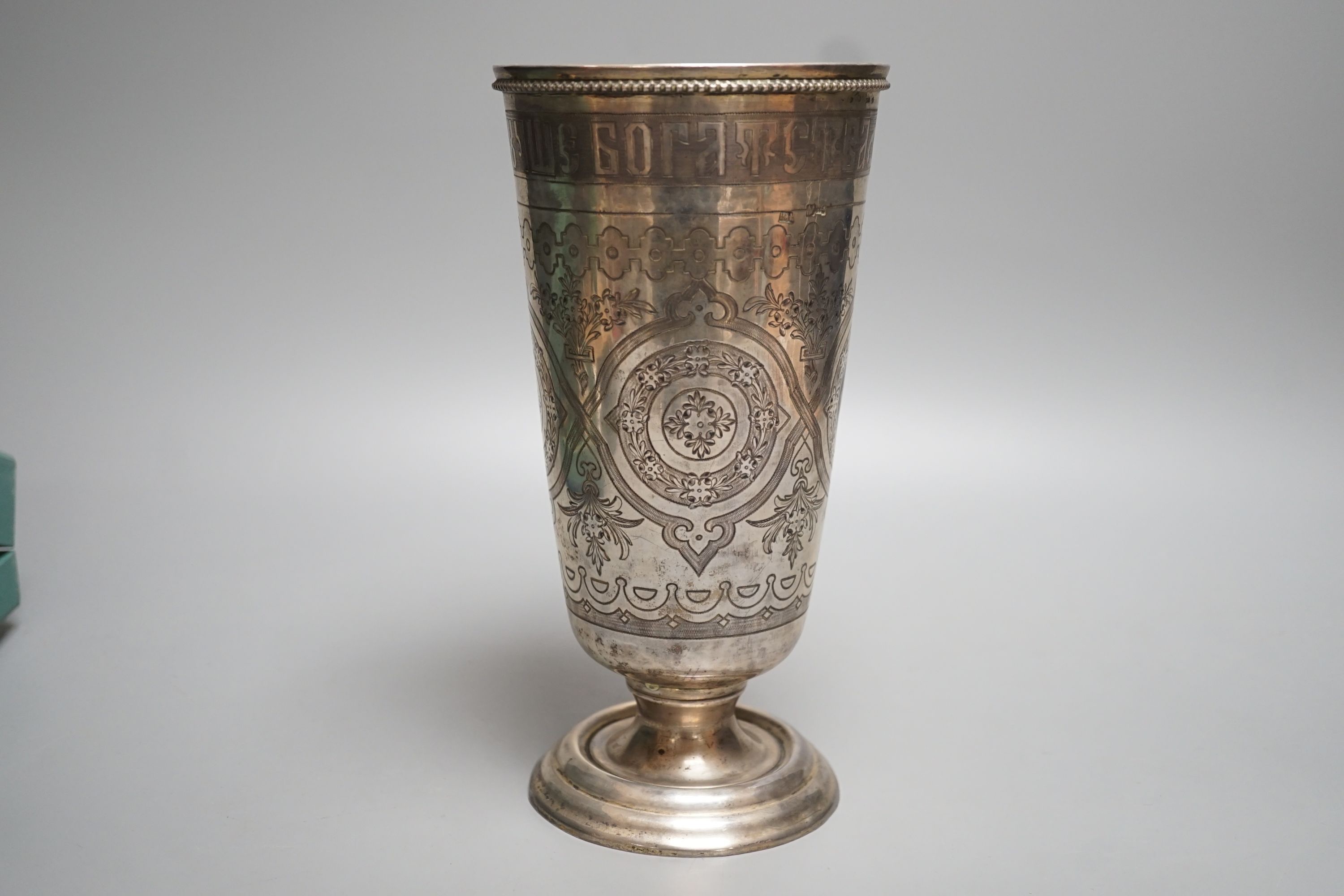 A continental white metal and niello vase, with inscription and decorated with foliate scrolls, 22.6cm, gross 15oz.
